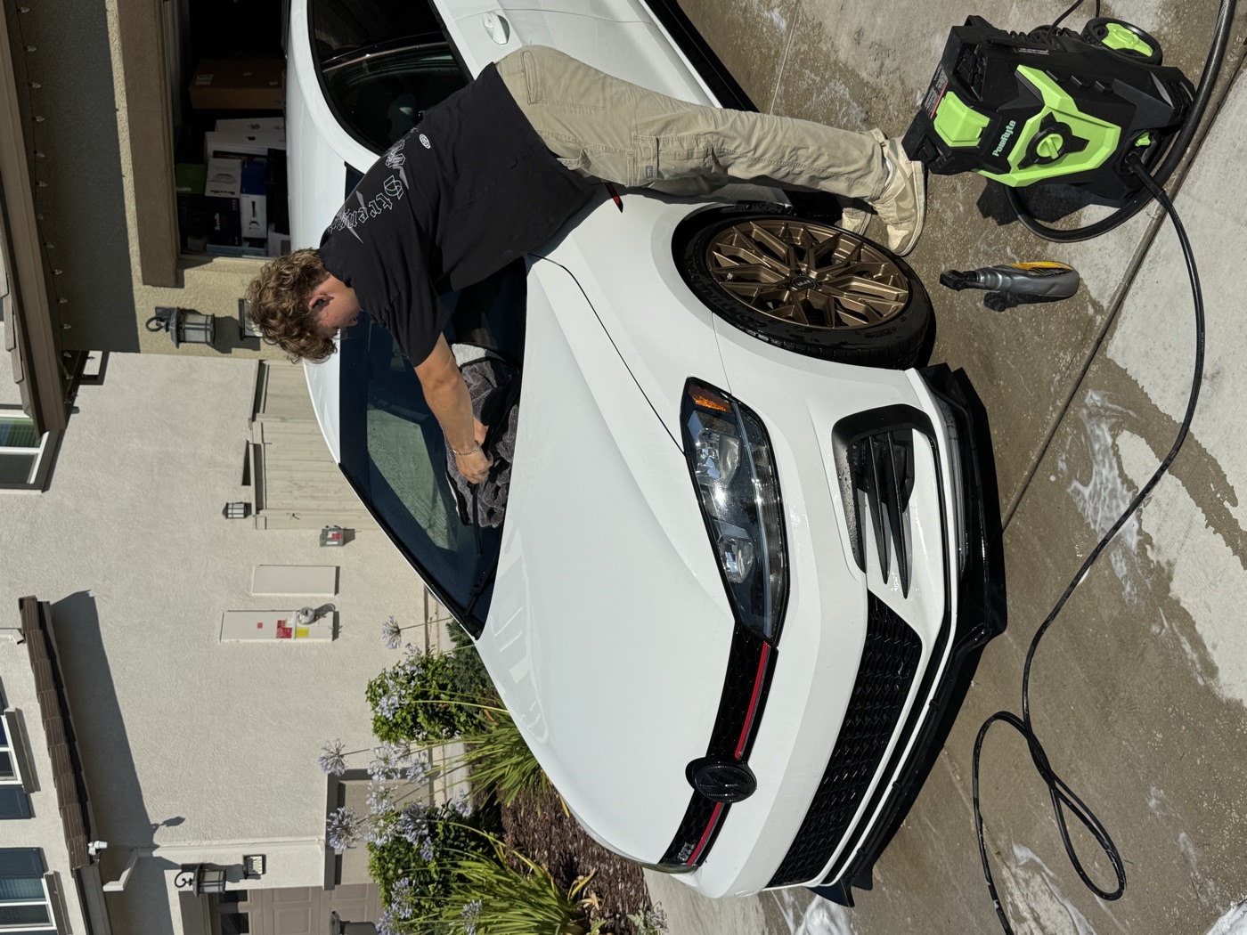 Exclusive Detailing owner hand-drying a freshly detailed GTI with a microfiber towel